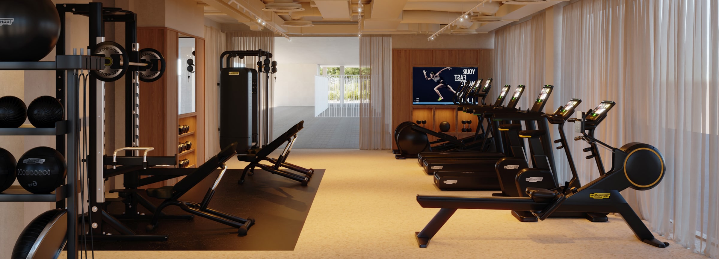 Gimnasio con máquinas de cardio y pesas en la residencia universitaria de Cantoblanco.