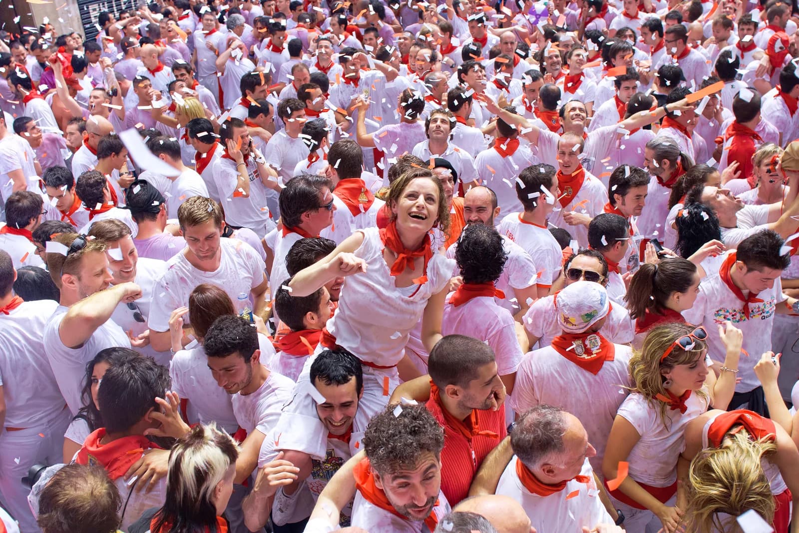 a crowd dressed in red and white during the San Fermín festival in Pamplona